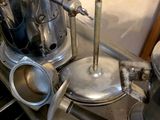 a silver stove top with a coffee pot on top of it
