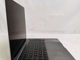 an open laptop computer sitting on top of a white surface