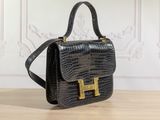 a black handbag sitting on top of a wooden table