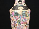 a vase that is sitting on a stand on a black background