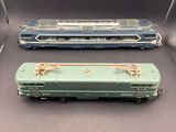 three toy train cars are lined up in a row on a gray surface