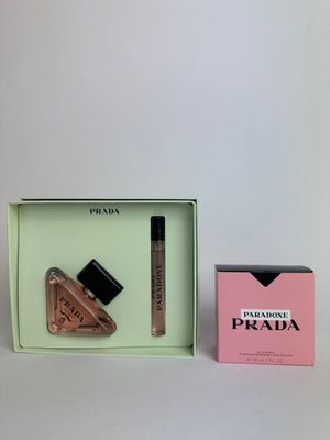 a box with a bottle of liquid and a lipstick in it
