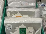 many bags of toilet paper sitting in a green bin