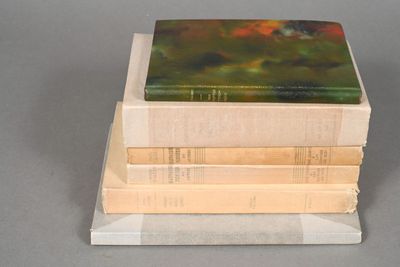 three books stacked on top of each other on a table