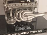 a model of a motor engine on display in a glass case