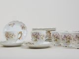 a lot of cups and saucers sitting on a table