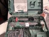 a green case with tools inside of it on a table