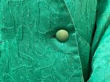 a close up of a person wearing a green jacket