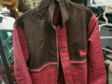 brown and red jacket hanging on a rack in a store