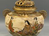 a vase with a lid that has a picture of a woman on it