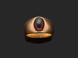 an oval gold ring with a garnetite stone