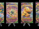 three packs of pokemon trading cards on a black background