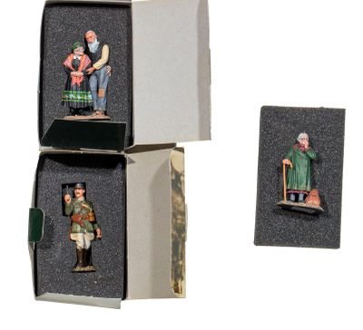 three miniature figurines of people in a box