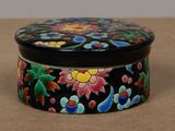 a black box with colorful flowers on it on a table