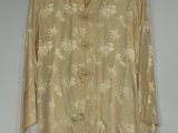 an image of a beige shirt with white flowers on it