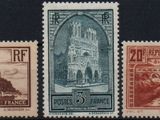 four different postage stamps with a picture of a church in the background