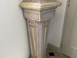a statue of an owl on a pedestal in a room