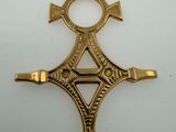 an image of a gold cross on a white surface