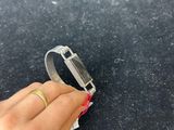 someone is holding a piece of paper with a ring on it