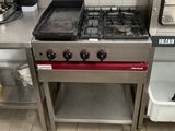 a kitchen with a stove, oven, and sink in it