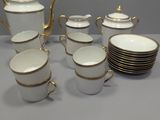 a lot of cups and saucers sitting on a table