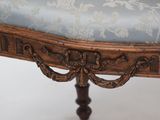 a wooden table with a blue upholstered seat