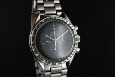 a close up of a watch on a black background