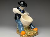 a figurine of a man sitting on a piece of bread