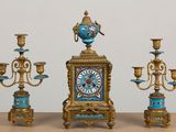 three different types of clocks sitting on a table