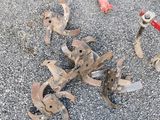 a red fire hydrant sitting on the ground next to a pile of rust
