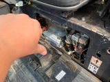a hand that is pointing at a car ' s engine