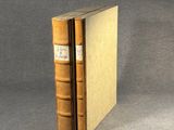 an old book sitting on top of a table next to a gray background