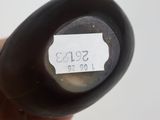 a black object with a label on it in a person ' s hand