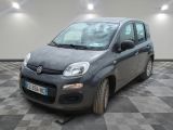 La petite voiture grise est garée dans le garage, sur un sol à damier.