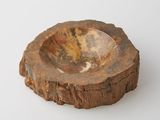 a small bowl that is sitting on a piece of wood