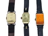 three different types of watches are displayed on a white surface