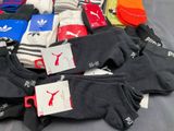 many pairs of socks that are sitting on a bed