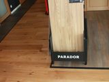 a wooden floor in a store with a display case on it