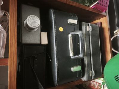 a black suitcase sitting on top of a wooden shelf