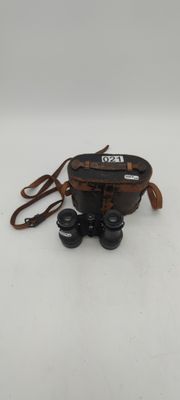 an image of a pair of binoculars sitting on top of a white surface