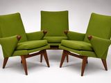 a group of three green chairs sitting next to each other