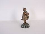 statue of a little girl with a bag on a marble base