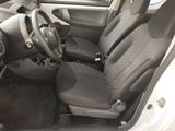 the interior of a small car with a steering wheel and seat covers