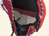 a red bag with a black and white design on it