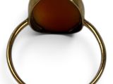 an image of a gold ring with a red stone in it