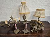 a table with a lamp, a lamp shade, and other items on it