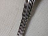 a silver spoon and a fork on a table