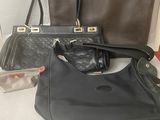 two black and one brown purses and one brown purse