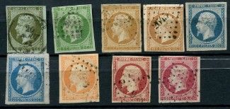 six different colored stamps of different sizes and shapes on a black surface