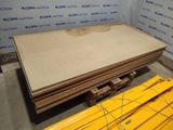several pieces of plywood sit on a pallet in a room